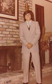 A person in a suit standing in front of a brick wall

AI-generated content may be incorrect.